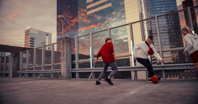 Multiethnic Diverse Group of Friends Playing Soccer on Rooftop Urban City Spot at Sunset. Stylish Young Man Dribbling, Passing Opponents Alone with the Ball, Goalkeeper Saving the Ball