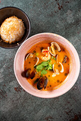 pan asian food. Tom Yum soup in bowl on table background