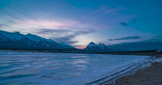 beautiful morning peach rose sunrise over frozen lake abraham with canadian rocky mountains on background