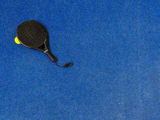 Padel ball with racket on Padel court