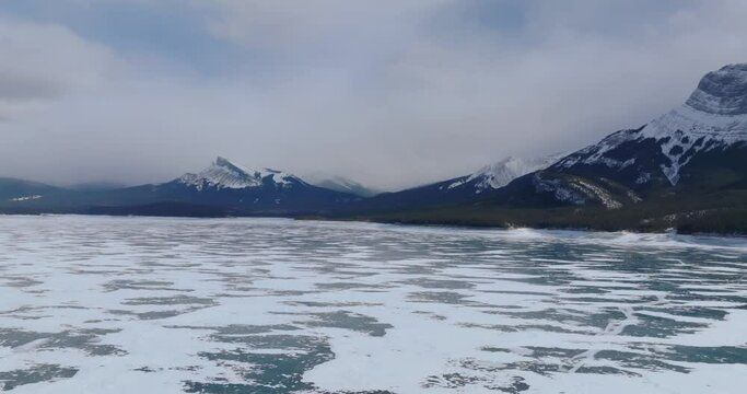 aerial view frozen lake abraham with canadian rockie mountains on background during sunny day