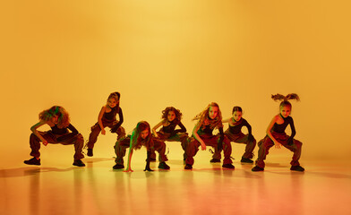 Hip-hop dance performance. Stylish, talented little girls, children in stylish clothes dancing...