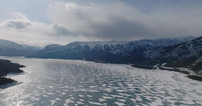aerial view frozen lake abraham with canadian rockie mountains on background during sunny day