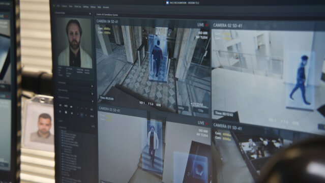 Close up shot of computer screen showing footage of surveillance cameras in coworking office with modern face recognition system. CCTV cameras. High tech security system. Concept of social safety.