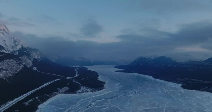 aerial view of morning winter mountain landscape over frozen abraham lake in canadian rockies