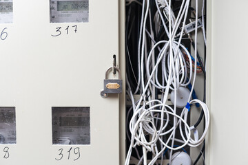 Electric cabinet with Internet and television cables in an apartment building. Niche for wires and cables inside the wall