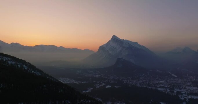 aerial view of Mount Rundle and city of Banff during winter sunrise