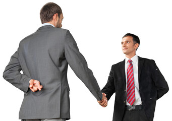 Portrait of Two Businessmen Shaking Hands while Crossing Fingers Behind Back
