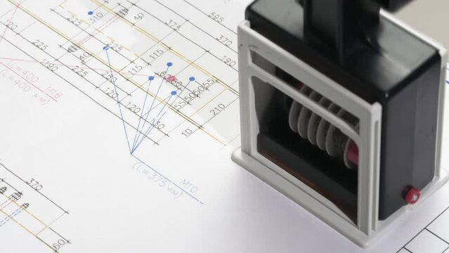 Construction Drawing Approval. A stamp is placed on the design drawing and leaves an ink imprint symbolizing compliance with standards and building permission