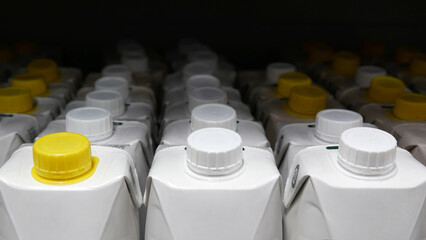 Fototapeta premium Close-up of many cardboard packs of juice standing in a row.