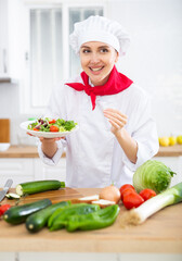 Female chef demonstrating excellent salad in the kitchen