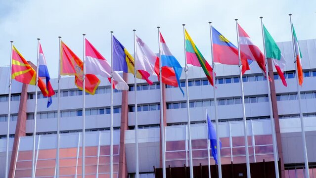 Strasbourg, France, August 2021: Many National Flags In Front Of Building Of International Organization Council Of Europe, Concept Of Standards Of Law, Human Rights And Cultural Interaction