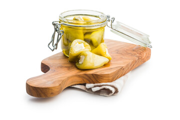 Peppers stuffed with cream cheese in jar isolated on white background.