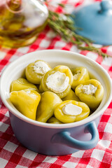 Peppers stuffed with cream cheese in pot.