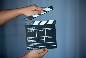 man hand holding film Slate (Clapboard)
