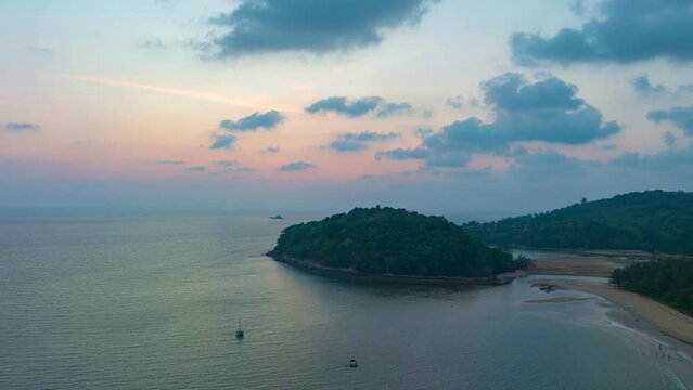 aerial hyperlapse view colorful sky of sunset above Kala island at Layan beach Phuket..video 4K. Nature video High quality footage. .Scene of Colorful romantic sky in sunset with cloud 