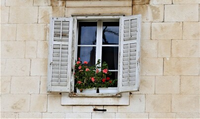Fototapeta na wymiar White vintage window with flowers mediterranean style