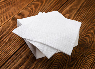 Paper napkins close up on a wooden background.