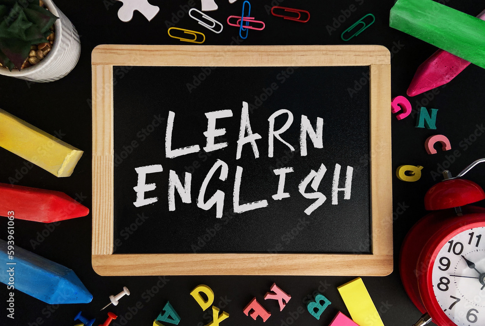 Poster wooden board with learn english text on a background of various colorful subjects