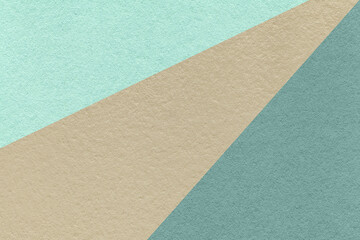 Texture of old craft cyan, teal and beige color paper background, macro. Vintage abstract cardboard