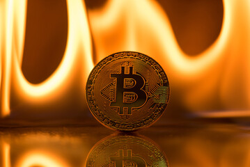bitcoin on fire flames background
