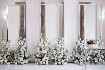 Fototapeta na wymiar wedding photo zone. white tulle and beige curtain decorated with a chic bouquet. Wedding reception for luxury ceremony in hall restaurant. Copy space. Celebration party concept. 
