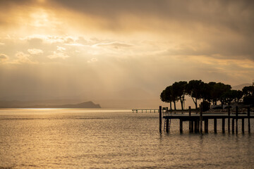 Fototapeta premium Golden sunset on the Italian Garda lake beach
