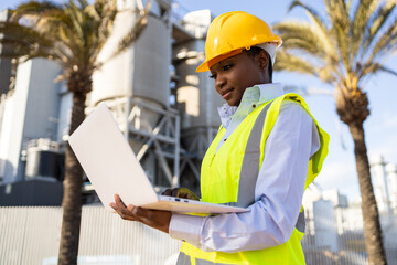 Black female engineering supervisor with laptop