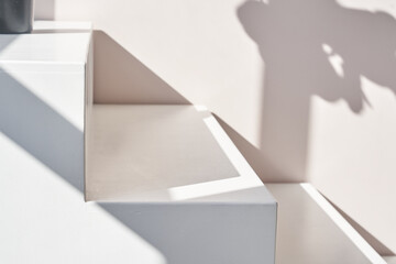 Stairs podium, stairs platform. Podium with stairs . Studio room background with sunlight and shadows for product demonstration. The shadow of geometry form. High quality photo