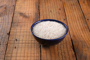 white rice natural long rice grain in porcelain bowl use texture background