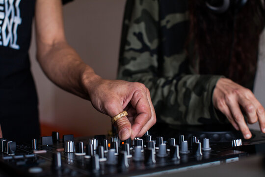 Couple of crop DJs playing music
