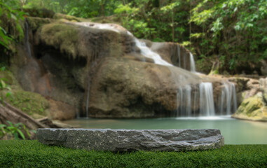 Fototapeta na wymiar Stone table top podium floor in outdoor waterfall green tropical forest nature background.Natural water product present placement pedestal counter display, spring summer jungle paradise concept.