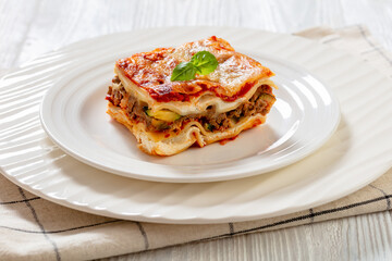 portion of Lasagna on white plate, top view