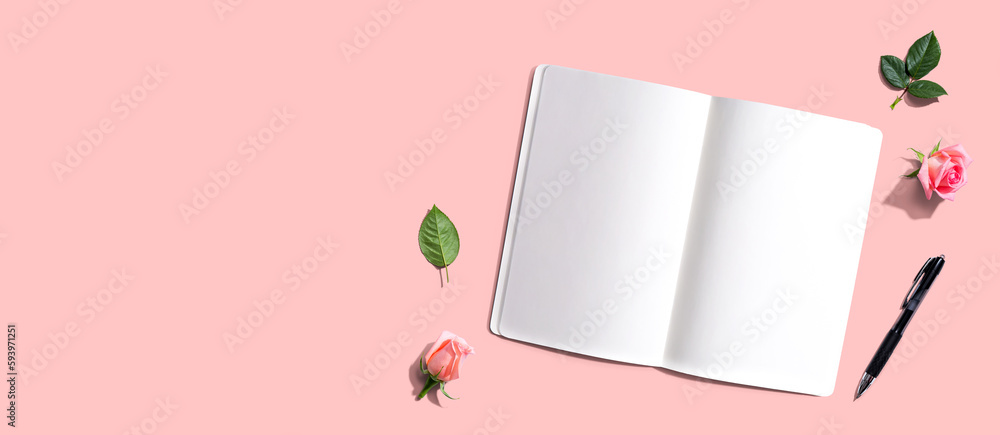 Poster open notebook or diary with a pen from above with rose buds- flat lay