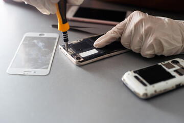 The technician repairing the smartphone's motherboard in the lab with copy space. the concept of...