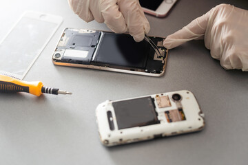 Technician prepairing to repair and replace new screen broken and cracked screen smartphone prepairing on desk.