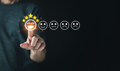 Man hand pressed the smile face emoticon on the virtual touch screen and give five star symbol to increase rating of products and services concept, Customer service and  satisfaction survey.