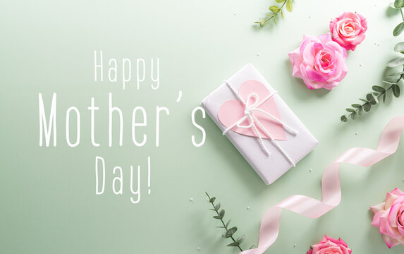 Happy Mother's day and Women's Day decoration concept made from flower gift box and the text on pastel background.