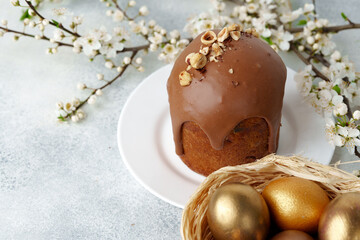Ester cake with chocolate topping and nuts on gray background