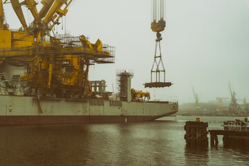 Ogromny statek z dźwigiem do montażu instalacji wiatrowych na morzu. Mglisty pochmurny dzień.  © Aneta