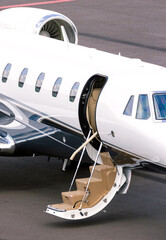 Modern corporate business jet on the tarmac of an airport.