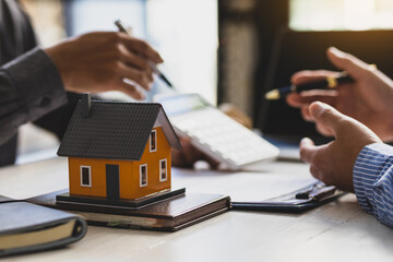 Real estate agent discuss about the terms of the home purchase agreement and asked the customer to...