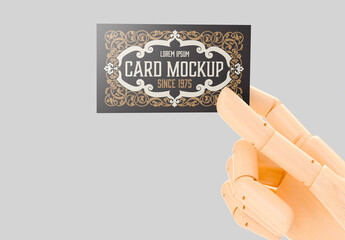 wooden mannequin hand holding business card mockup
