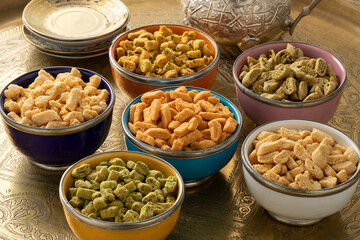 Colorful bowls with a variation of Moroccan crunchy miniature shortbread cookies called Krichlate for Ashura close up 