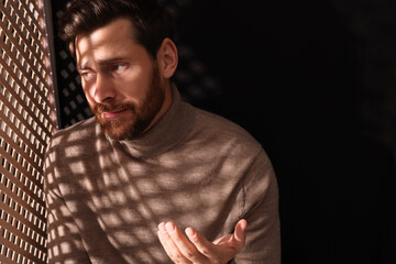 Man talking to priest during confession in booth, space for text