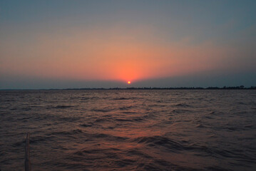 Fototapeta premium Beautiful view of sunset during boat journey through Bhitarkanika National Park, Odissa, India