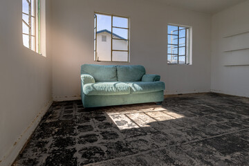 dusty couch in empty motel room