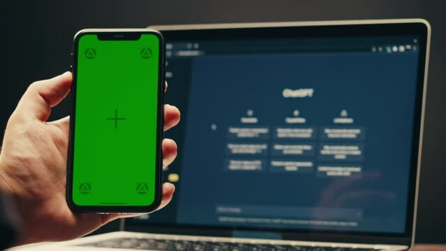 Phone with chroma key green screen with man working with chat gpt bot AI online, connecting with AI and using a chat GPT. IT engineer software developer programmer interact with