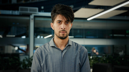 Displeased pensive sad thoughtful businessman indian arabian man entrepreneur office worker developer investor manager employee stand indoors thinking solving business problem suffer negative refuse