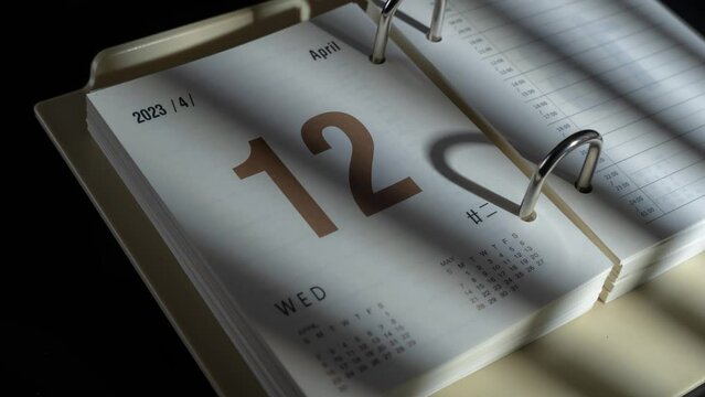 Closeup timelapse video of the changing dates in 2023 paper calendar